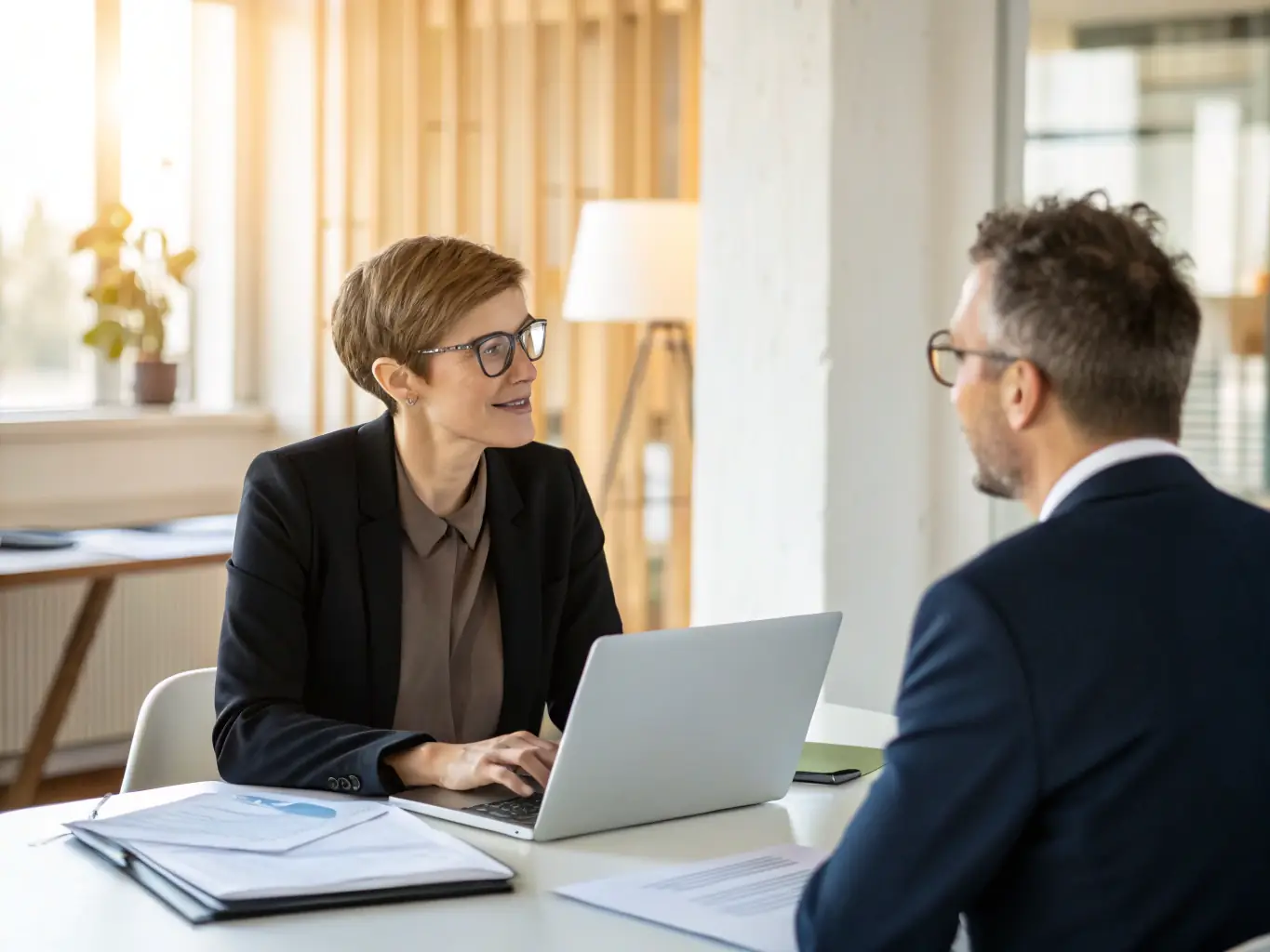 A professional consultant from LeadHire is in a meeting with a client, discussing recruitment strategies and understanding their specific needs, in a modern office setting.