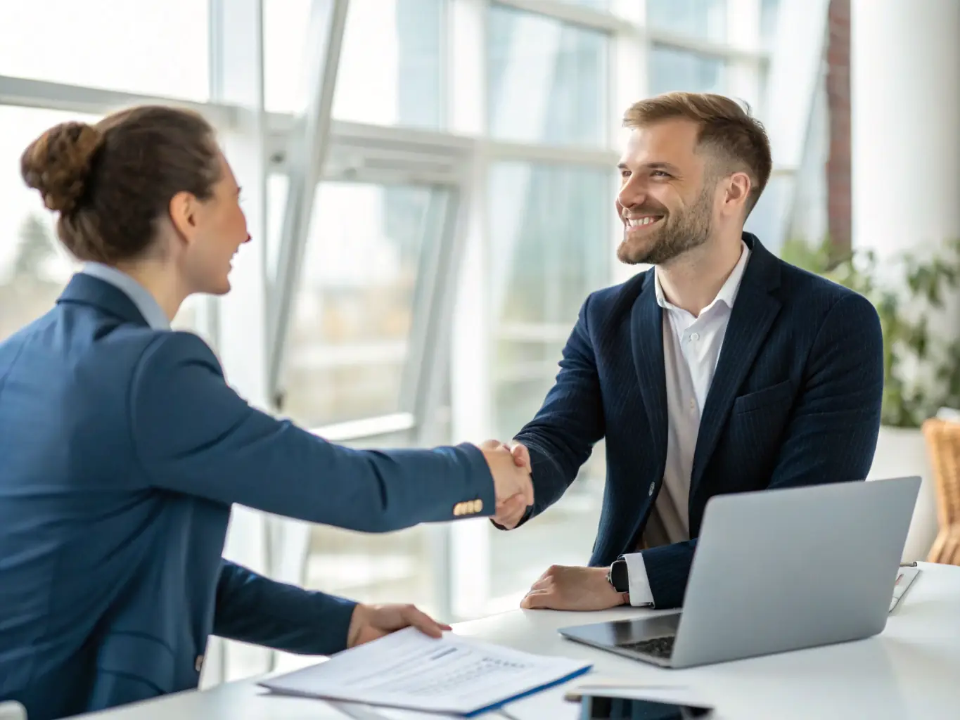 A candidate is receiving a congratulatory handshake from a LeadHire consultant after a successful job placement, symbolizing LeadHire's commitment to candidate success.